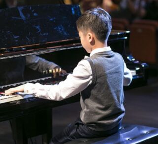 boy playing in piano recital charlotte academy of music